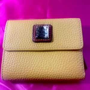 Dooney wallet yellow never used.